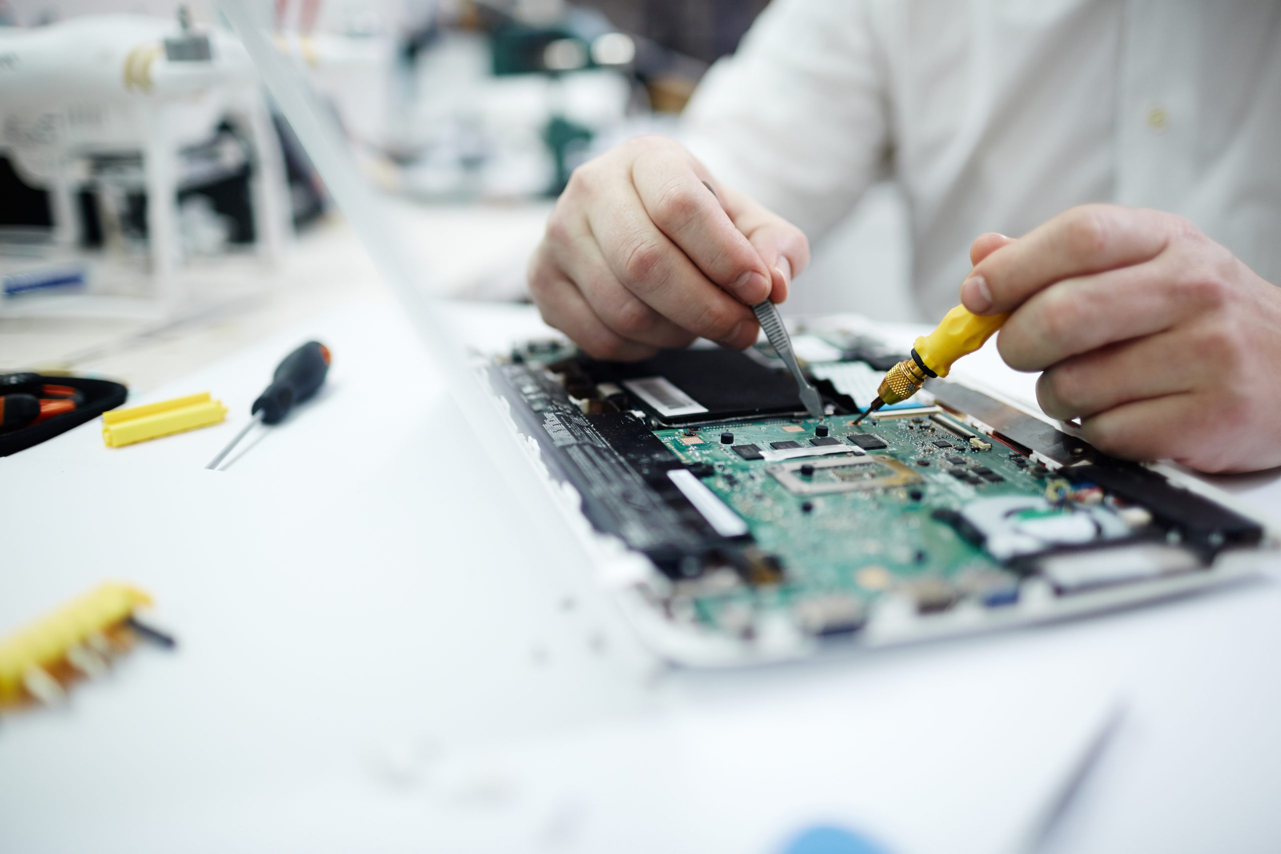 Man Repairing Circuit Board In Laptop